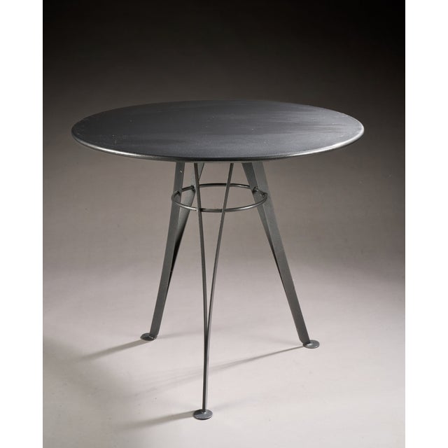 Pascal MOURGUE (1943-2014): Table with a circular top in speckled anthracite grey metal and a pair of armchairs in black...