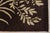 A 10' x 14' hand-knotted wool rug with a chocolate brown ground with large ivory botanical sprays and vines, in a low,...