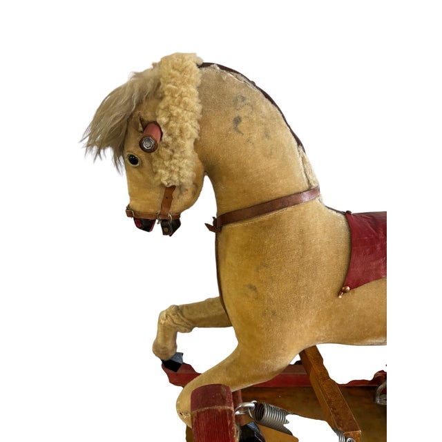 Full of nostalgic charm and evidence of a well-loved childhood, this antique spring-mounted nursery horse captures the...