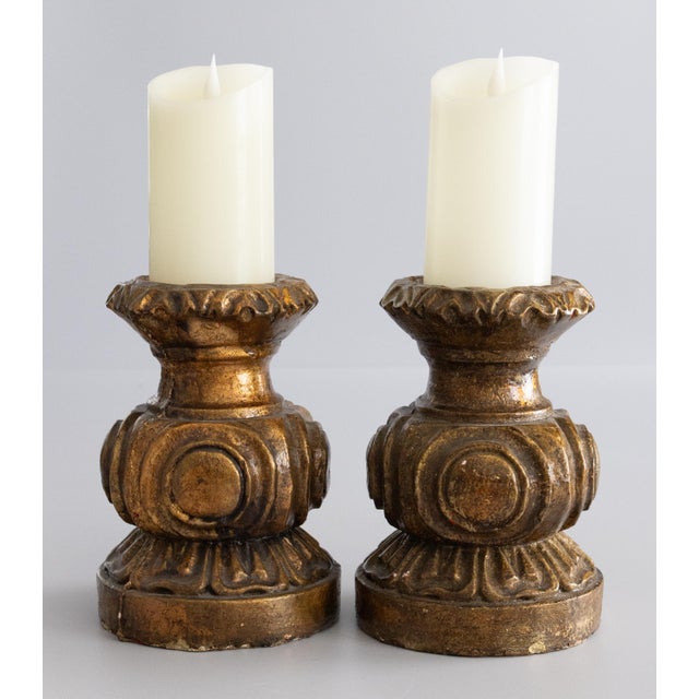 These vintage Italian plaster pillar candle holders feature an ornate carved design with warm, aged gilt tones. Their...