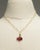 A striking and lovely oval-link, 18K gold chain with a optional gold bail drop. The drop is a cluster of faceted pink...