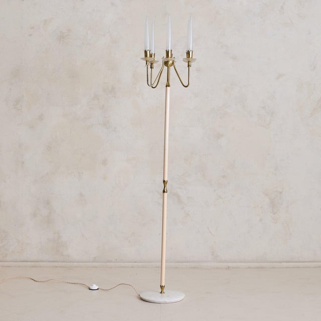 An Italian floor lamp by Angelo Lelii for Arredoluce, designed in 1953. The slender structure is crafted from brass and...