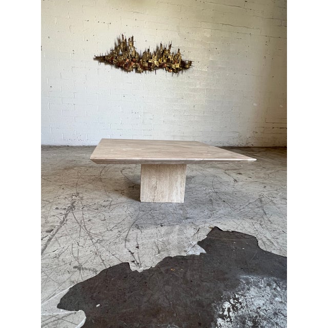 Vintage post modern travertine stone coffee table featuring a block pedestal base, and square top in creamy nuetrals and...