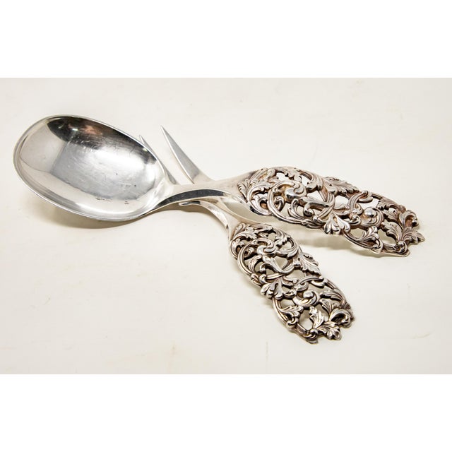 Offering this set of R. Elveseter sterling silver salad cutlery. Having ornate scrollwork and openwork detail on the...