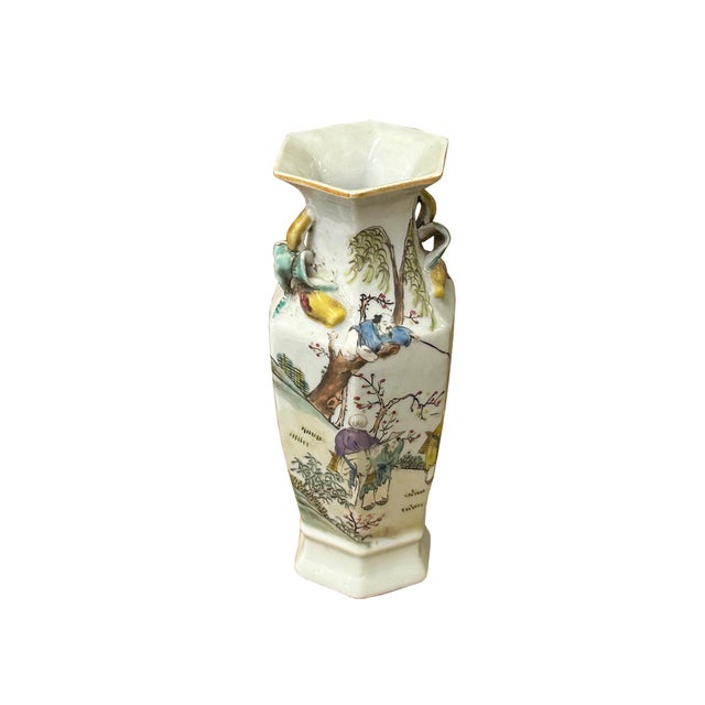 This elegant hexagonal porcelain vase features a tapered body that expands toward the shoulders, topped with a flared,...