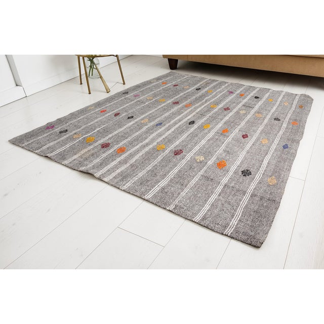 This is a vintage Turkish Oushak rug from the Mid 20th Century. The piece was hand-knotted.