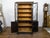 An English black and gold bookcase from the 19th century with Chinoiserie décor and glass doors. This exquisite English...