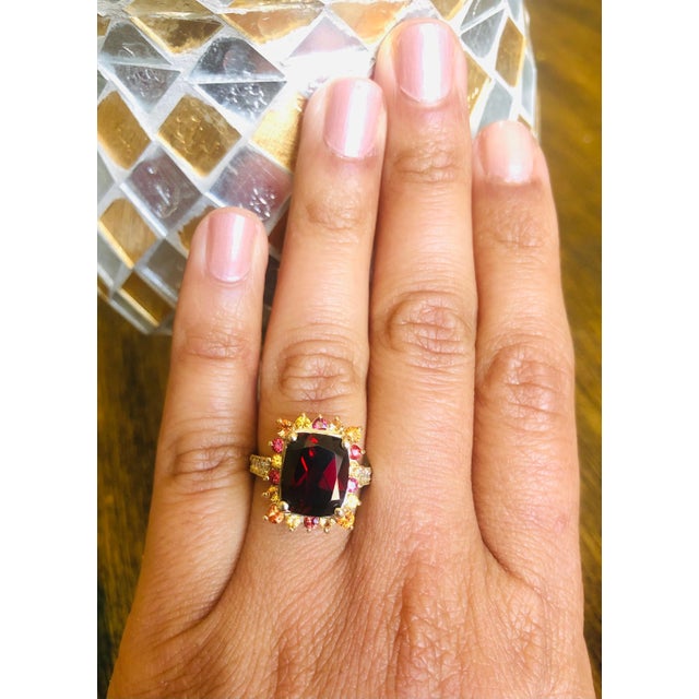 6.97 Carat Garnet Sapphire Diamond Yellow Gold Cocktail Ring This ring has a Oval/Cushion Cut Garnet weighing 5.63 carats...