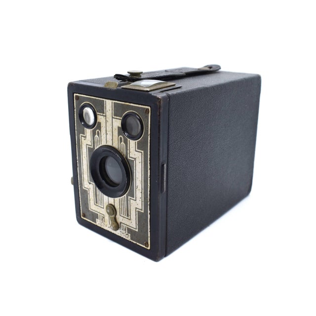 This Kodak Six-20 Portrait Brownie is a stunning piece of 1930s functional art. It features the iconic "geometric" Art...