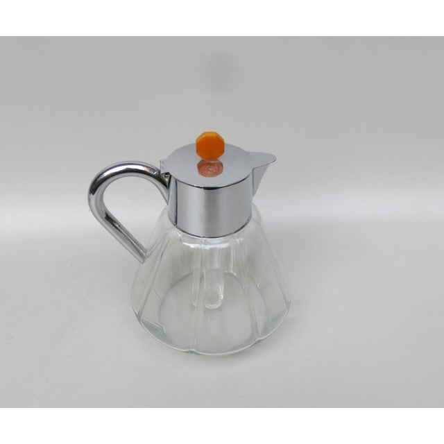 An elegant carafe from the time of Art Deco in the typically strict formal language. The carafe is bound -blown and shows...