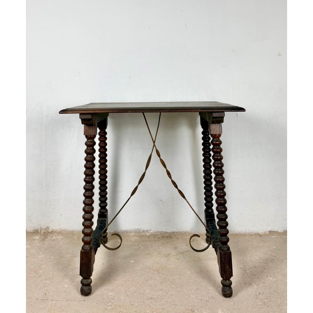 A charming Spanish side table crafted from solid wood, reflecting the enduring appeal of traditional Spanish...