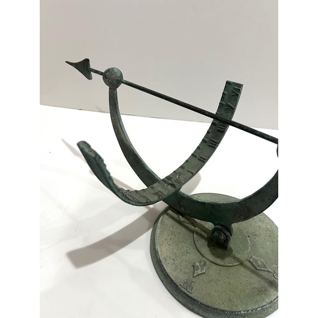 A rare find, Equatorial Sundial Patinated from France. Cast metal arrow form Gnomon Hinged at base. A great piece for your...