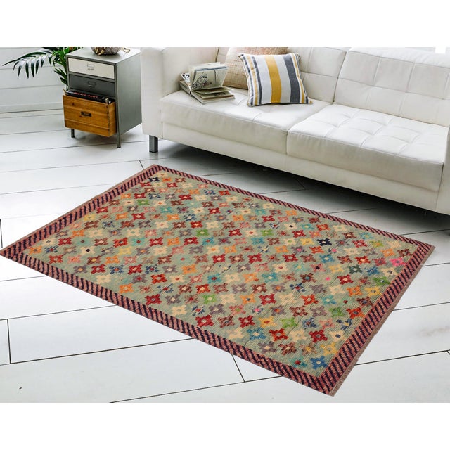 This stunning hand-knotted Afghan Balouchi rug is a captivating addition to any decor. Crafted by skilled artisans, it...