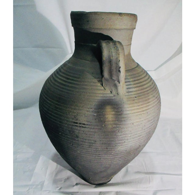 Hand-thrown clay jar fired in a kiln with carbon induction. Fired to blacken the clay as it hardens it. Egyptian Village...