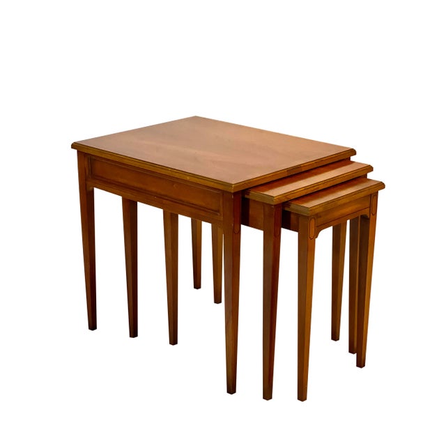 Mid 20th Century fruitwood nesting tables by Heritage, set of 3. The set meticulously fits together with built-in sliding...