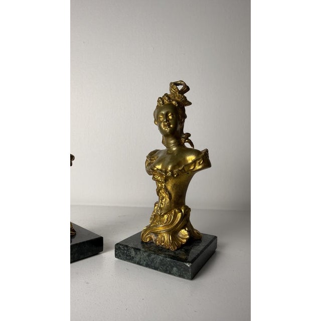 A pair of bronze sculptures depicting busts of female figures dating back to the Belle Époque period (19th century). The...