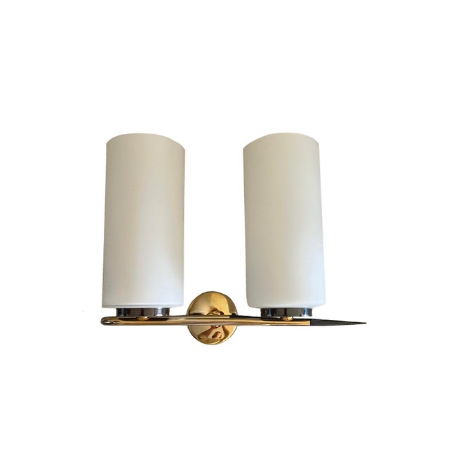 Double wall light wall light from the 1950s–1960s, featuring opaline glass shades, polished brass structure, and...