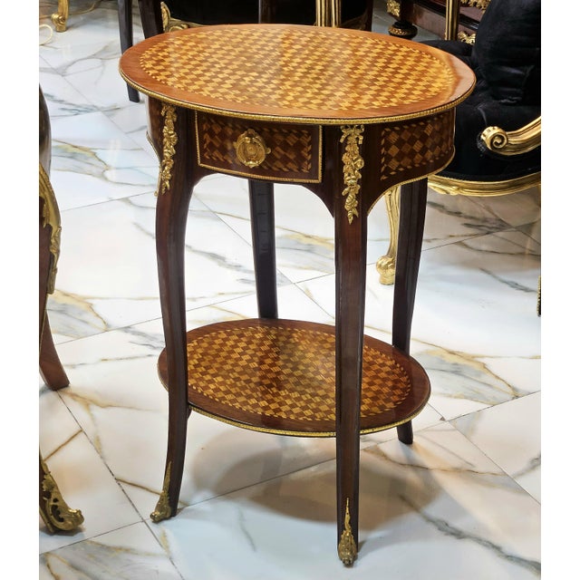 This French style wood side table is a luxurious statement piece that brings timeless elegance and refined craftsmanship...