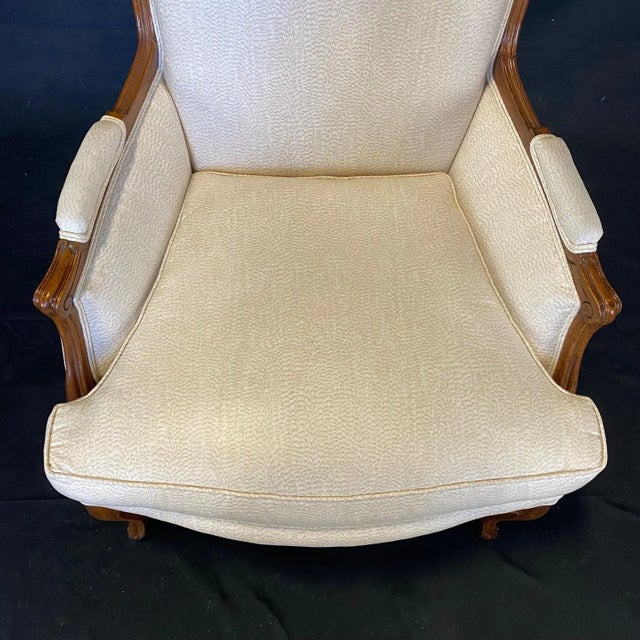 Fine walnut Louis XV style armchair in fine upholstery with wonderful carved details. This elegant neutral and finely...