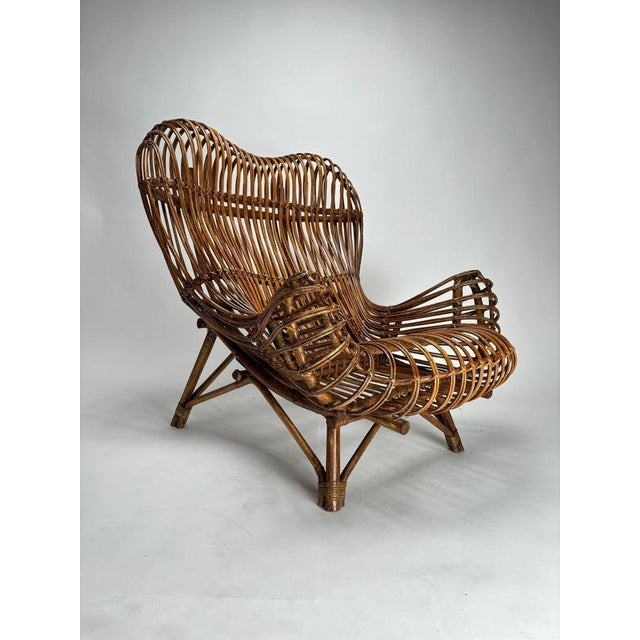 This pair of armchairs represents an iconic testament to postwar Italian design, designed by renowned architect and...