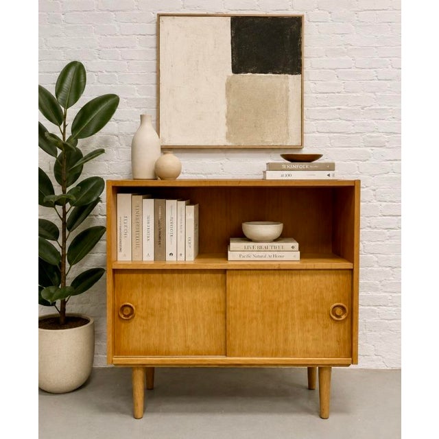 Mid Century Modern Oak Bookcase Cabinet featuring clean lines, sliding doors, and a roomy open shelf — perfect for books,...
