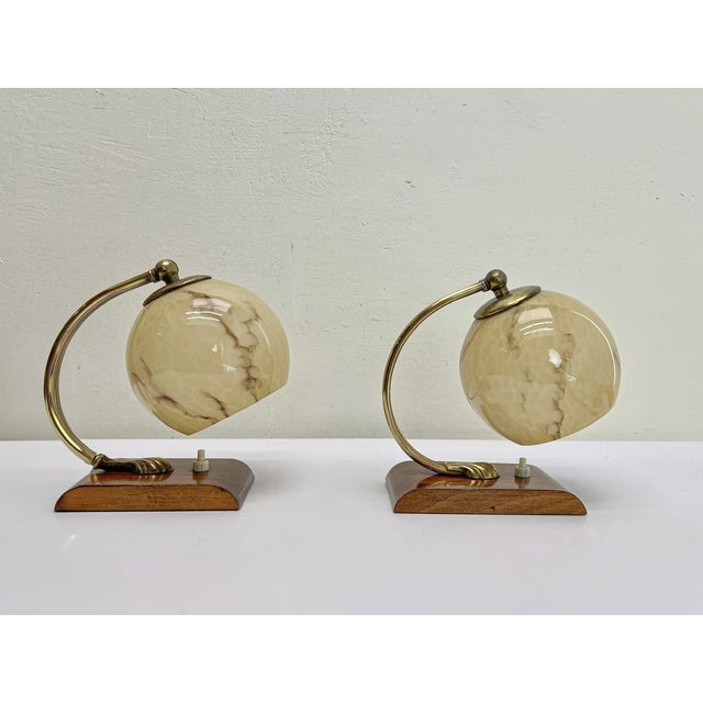 A set of bedside night lights Art Deco, walnut and brass and with brown-beige clouded glass. The lampshade can be rotated...