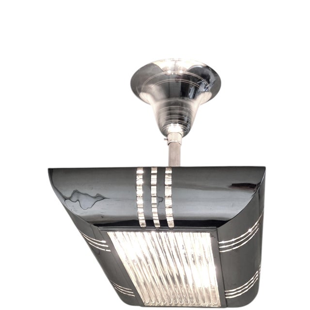 Exceptional French Modernist highly polished metal ceiling fixture, designed in the streamlined Art Deco / Machine Age...
