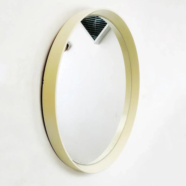 Round white plastic mirror, 1980s. Round mirror, medium size with white plastic frame with some yellowing shades. 1980s....