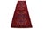 Persian Heriz wool rug, hand-knotted in vibrant red, featuring a multicolored accent throughout its intricate tribal...