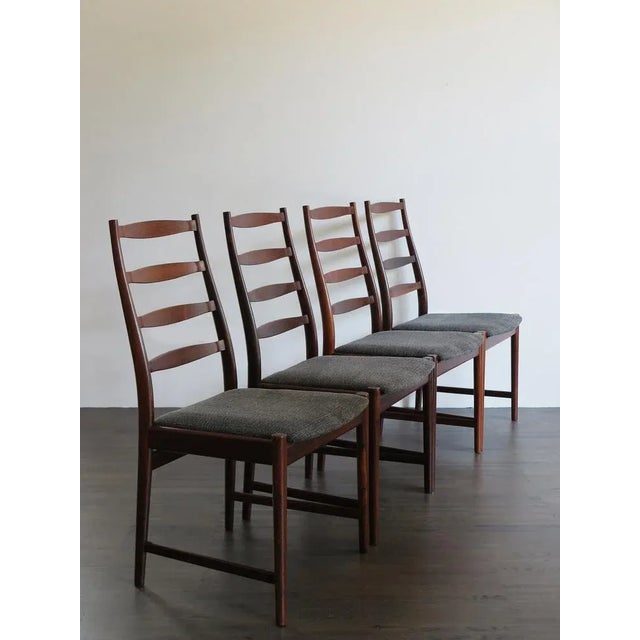 Two Danish chairs with solid dark wood structure designed by Arne Vodder (attributed), new upholstery, manufacturer's mark...