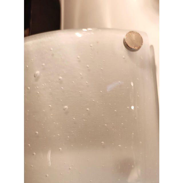 Stunning wall lamp dating back to the 1970s. The design stands out for its iconic geometric shape with three decreasing...