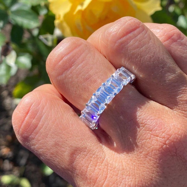 This is part of Chairish’s Fine Jewelry assortment. Introducing The Marise Emerald Cut Eternity Band from the Lumeniri...