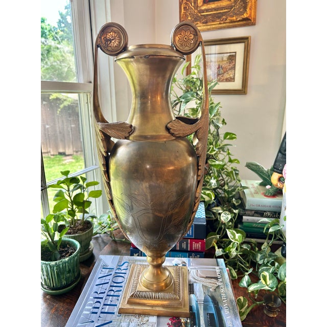 Perfect for an entry table or mantel , this cast brass urn shaped vase features handles fashioned as acanthus leaves. The...