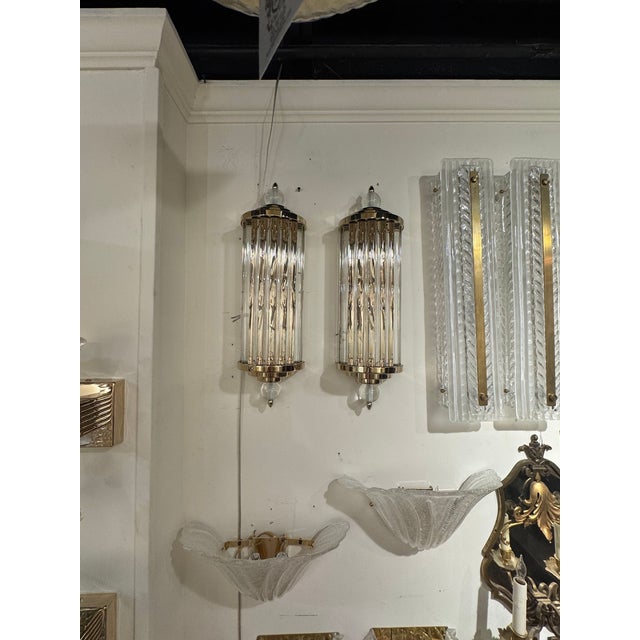 This product is a pair of elegant Murano glass and brass barber sconces, perfect for adding a touch of sophistication to...
