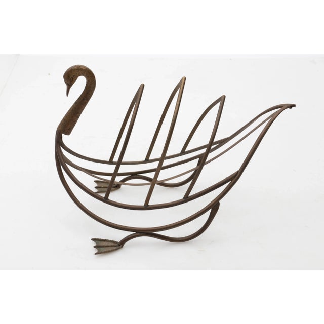 Maison Jansen brass magazine rack in the shape of a swan with original patina, circa 1960s. Please note of wear consistent...