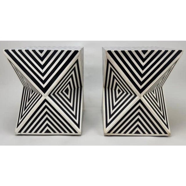 The pair of Art Deco style sculptural side, end tables or stools features a triangle / diamond design narrowing in the...