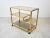 This vintage brass and smoked glass serving cart features unique midcentury design, combining simple lines and plenty of...