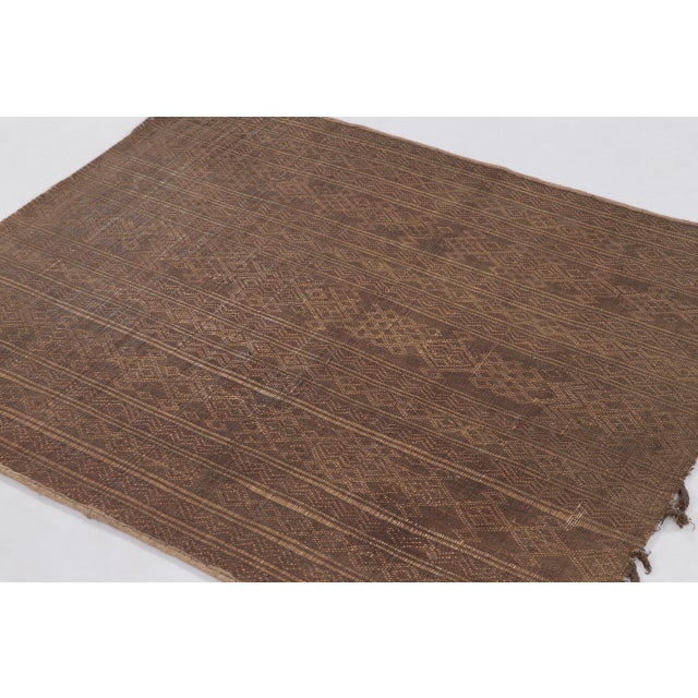 This vintage Moroccan Tuareg square 4x4 mat, dating to circa 1950-1960, reflects the distinctive weaving traditions of the...