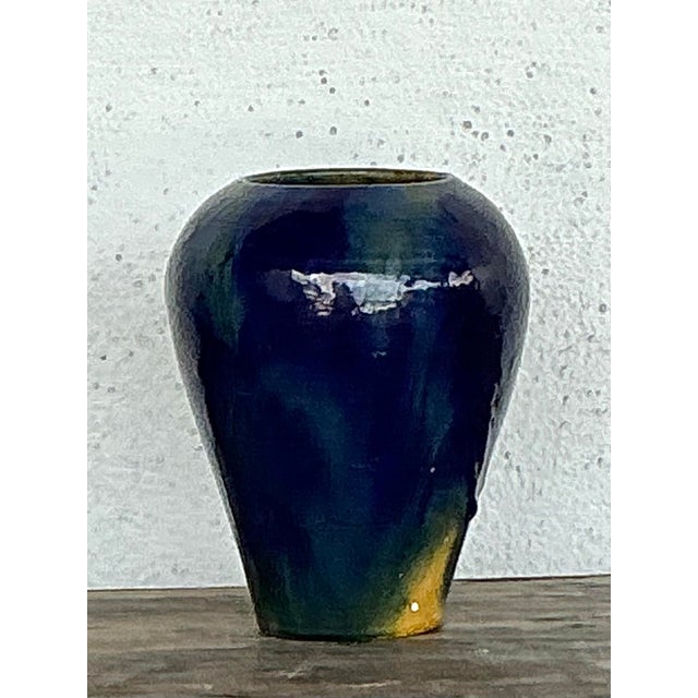 This striking vintage studio pottery vase is a masterclass in artisanal glaze and organic form. Expertly hand-crafted, the...