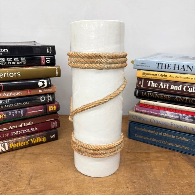 "About This Piece About This Piece This striking ceramic vase captures attention with its tall cylindrical form and...