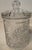 Vintage clear glass lidded biscuit jar featuring a classic cut crystal-style pattern with fan and starburst motifs. This...