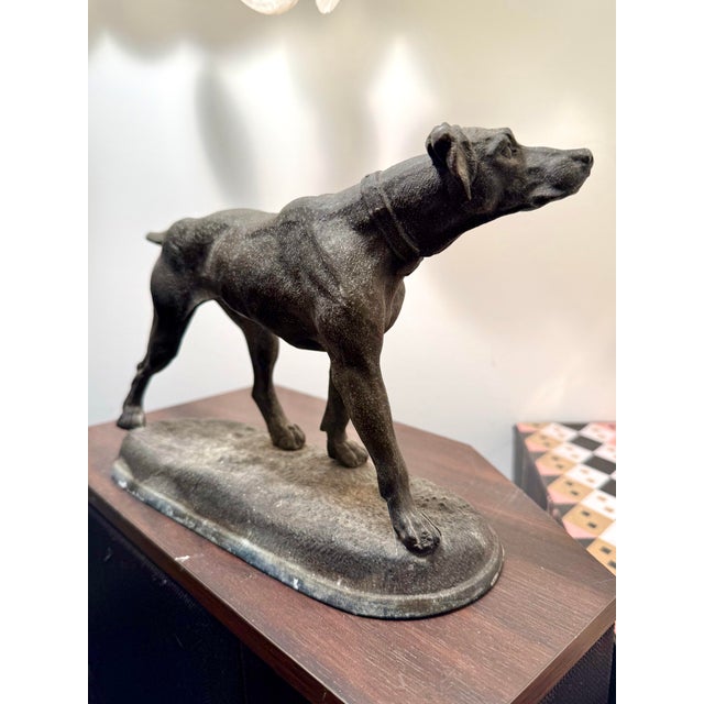 Beautifully detailed cast metal statue of a large breed dog- perhaps a pointer, hound, or Weimaraner. The face is...
