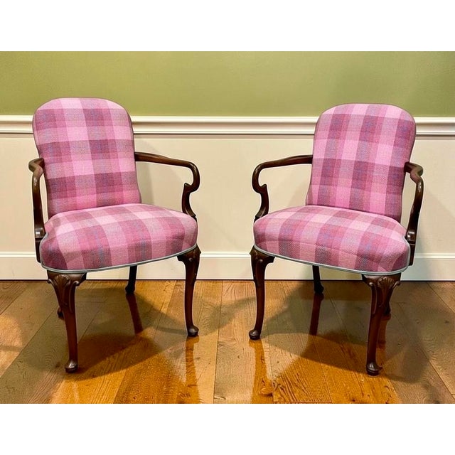 This pair of Northern European Rococo style chairs have elegant tendril like curved arms and seashell motifs popular in...