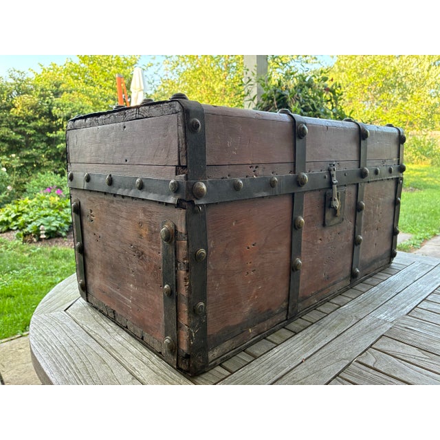 An exceptional 19th-century Victorian period traveling cabin trunk crafted from warm, solid pine wood. This low-profile,...