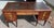 Elegant French Neoclassical-style writing desk featuring a rich mahogany case with inset tooled leather top and finely...