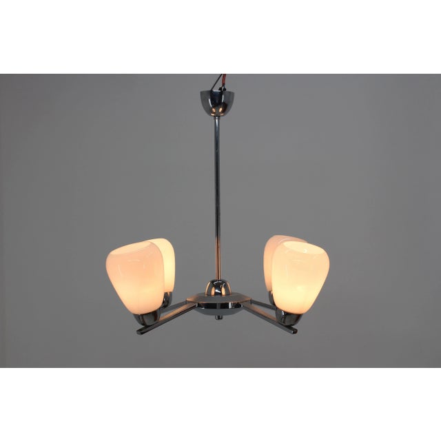 Chrome-plated chandelier in original condition, 4xE27 or E26 bulbs. Up to 250V (Europe/UK Standard).The wiring of this...