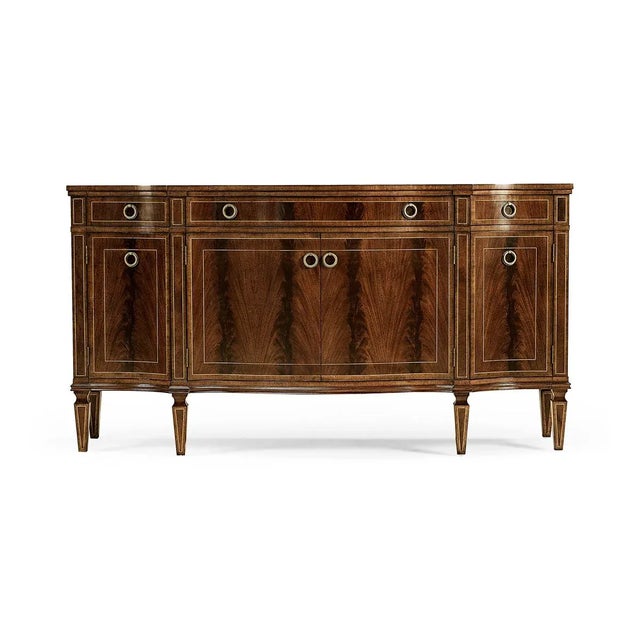 Substantial George III style bow fronted serpentine sideboard with four doors, flame mahogany veneers, and three drawers...