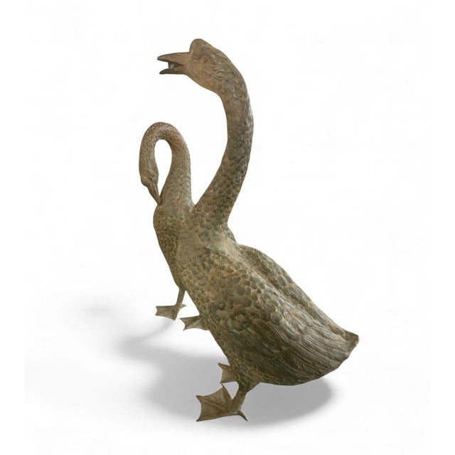 Elevate your outdoor space with this impressive, patinated bronze fountain depicting a pair of noble waterfowl, likely...