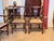 A set of eight mahogany armchairs with carved pierced splats, shaped top rails with carved details at the corners, and...