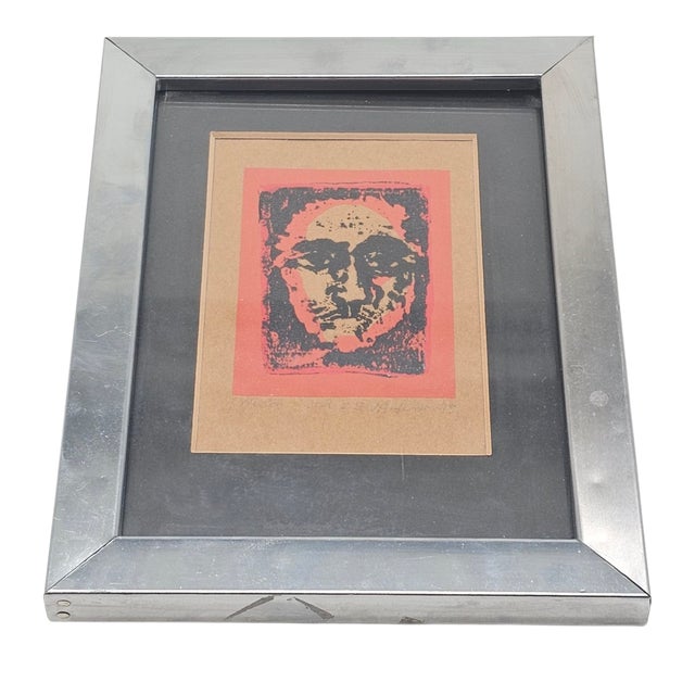 A face—half shadow, half flame—emerges from the grain of handmade print. J. Anderson, New Orleans artist, captures a...
